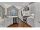 Bright kitchen with stainless steel appliances, white cabinets, and a gas range at 7800 Twin Pines Way, Fuquay Varina, NC 27526