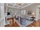 Elegant living room with high coffered ceilings, hardwood floors, a fireplace, and arched windows at 7800 Twin Pines Way, Fuquay Varina, NC 27526