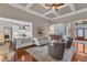 Open-concept layout connecting the living room, dining area and kitchen, with hardwood floors and neutral tones at 7800 Twin Pines Way, Fuquay Varina, NC 27526