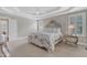 The main bedroom features a decorative bed, detailed trim, and two large windows at 7800 Twin Pines Way, Fuquay Varina, NC 27526
