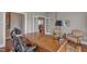 Office area showcasing an executive desk, chair and hardwood floors, with an open view to the rest of the house at 7800 Twin Pines Way, Fuquay Varina, NC 27526