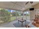 Relaxing screened porch with vaulted ceiling, ceiling fan, comfortable furniture and wooded backyard views at 7800 Twin Pines Way, Fuquay Varina, NC 27526