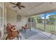 Cozy screened porch with wicker furniture, a ceiling fan and scenic views at 7800 Twin Pines Way, Fuquay Varina, NC 27526