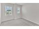 Bedroom featuring neutral walls, carpet flooring and two large windows at 816 Lilyquist Way, Wake Forest, NC 27587