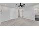 Spacious bedroom with neutral walls, carpet flooring, ceiling fan, and attached bathroom at 816 Lilyquist Way, Wake Forest, NC 27587