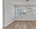 Bright dining room featuring wood floors, large windows, and a modern rectangular light fixture at 816 Lilyquist Way, Wake Forest, NC 27587