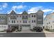 Townhome exteriors with two-car garages and grey and white paint scheme at 816 Lilyquist Way, Wake Forest, NC 27587