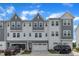 Modern two-story townhome featuring a two car garage, neutral gray tones and professional landscaping at 816 Lilyquist Way, Wake Forest, NC 27587