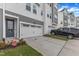 Modern gray townhome with a two-car garage, neat landscaping, and a secure CPI security sign at 816 Lilyquist Way, Wake Forest, NC 27587