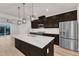 Bright kitchen features stainless steel appliances, a central island, hardwood floors, and sliding glass doors overlooking a lake at 816 Lilyquist Way, Wake Forest, NC 27587