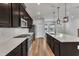 Bright kitchen showcases dark wood cabinets, modern appliances, a central island, and sleek white backsplash at 816 Lilyquist Way, Wake Forest, NC 27587