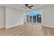 Bright living room features hardwood floors, ceiling fan, and sliding glass doors to a deck at 816 Lilyquist Way, Wake Forest, NC 27587