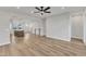 Bright, open-concept living room showcasing hardwood floors and seamless transitions to kitchen and staircase at 816 Lilyquist Way, Wake Forest, NC 27587