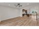 Open living area featuring hardwood floors, a view of the modern kitchen with stainless steel appliances at 816 Lilyquist Way, Wake Forest, NC 27587