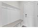 Bright mudroom features coat hooks, bench seating, and storage, enhancing functionality and organization at 816 Lilyquist Way, Wake Forest, NC 27587