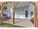 Covered patio with concrete flooring, a grill, white siding, and natural wood supports at 816 Lilyquist Way, Wake Forest, NC 27587