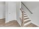Interior staircase with natural wood and bright white accents, complemented by modern flooring at 816 Lilyquist Way, Wake Forest, NC 27587