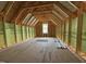 Unfinished attic featuring natural lighting and ample space, ready to be transformed into a functional area at 82 Laramie Ln, Selma, NC 27576
