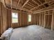 Bedroom space with two windows and wooden framework for walls and overhead lighting fixtures at 82 Laramie Ln, Selma, NC 27576