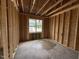 Bedroom showing wooden framework and window overlooking the outdoors with puddles on the floor at 82 Laramie Ln, Selma, NC 27576