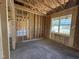 Unfinished bedroom featuring natural light from the window and bare studs ready to be customized at 82 Laramie Ln, Selma, NC 27576