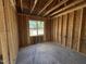 Unfinished bedroom with natural lighting and bare studs, ready for your custom design at 82 Laramie Ln, Selma, NC 27576