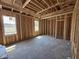 Unfinished bedroom featuring natural lighting and bare studs, ready to be customized at 82 Laramie Ln, Selma, NC 27576