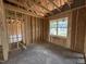 Bedroom with wood framing, space for a large window, and views of a nearby neighborhood at 82 Laramie Ln, Selma, NC 27576