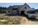 Charming two-story new home with classic architectural details awaiting finishing touches at 82 Laramie Ln, Selma, NC 27576