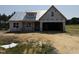 Under construction home featuring a covered porch and spacious two-car garage at 82 Laramie Ln, Selma, NC 27576