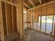 Unfinished garage featuring bare studs, ready to be customized for storage or parking at 82 Laramie Ln, Selma, NC 27576