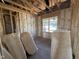 A framed room with insulation showcases the blank canvas for creating your dream living space at 82 Laramie Ln, Selma, NC 27576