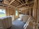 Large future room ready for finishing touches with insulation, windows, and exposed framing at 82 Laramie Ln, Selma, NC 27576