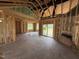 Unfinished living room shows framed construction with exposed beams, vaulted ceilings, sliding glass doors and lots of natural light at 82 Laramie Ln, Selma, NC 27576