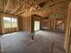 Unfinished living room featuring an open layout with access to the backyard through a sliding glass door at 82 Laramie Ln, Selma, NC 27576