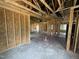 Unfinished living room shows framed construction, exposed beams, high ceilings and framed walls at 82 Laramie Ln, Selma, NC 27576