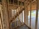 Wood frame stairway leading to the second floor, with natural light streaming in from the garage at 82 Laramie Ln, Selma, NC 27576