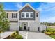 Charming townhouse with a two-car garage, a mix of gray shingles and white panels, and manicured landscaping at 825 Kensley Grove Ln # 19, Fuquay Varina, NC 27526