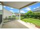 Covered back porch provides great backyard views, a well-manicured lawn, and black metal fencing at 826 Downfield Ln, Fuquay Varina, NC 27526