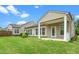 Green backyard with covered patio and white pillars, providing ample outdoor space for entertaining at 826 Downfield Ln, Fuquay Varina, NC 27526