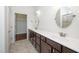 Bathroom with a double sink vanity, mirrors, tile flooring, and a walk-in closet at 826 Downfield Ln, Fuquay Varina, NC 27526