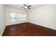 Cozy bedroom with hardwood floors, a ceiling fan, and window at 826 Downfield Ln, Fuquay Varina, NC 27526