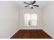 Cozy bedroom featuring hardwood floors, a ceiling fan, and a window providing natural light at 826 Downfield Ln, Fuquay Varina, NC 27526