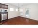 Bright dining area with stainless steel appliances and an adjacent door to the backyard at 826 Downfield Ln, Fuquay Varina, NC 27526