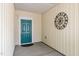 Inviting entryway featuring a teal door and decorative metal artwork enhancing curb appeal at 826 Downfield Ln, Fuquay Varina, NC 27526