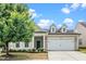 Charming single-Gathering home featuring a well-manicured lawn, two-car garage, and inviting curb appeal at 826 Downfield Ln, Fuquay Varina, NC 27526