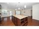 Large kitchen island with granite countertop, storage, and pendant lighting, perfect for entertaining at 826 Downfield Ln, Fuquay Varina, NC 27526