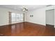 Spacious living room with hardwood floors, crown molding, ceiling fan, and ample natural light at 826 Downfield Ln, Fuquay Varina, NC 27526
