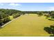 Aerial view outlining property on a sprawling green lawn with a farmhouse and outbuildings at 8365 Aaron Creek Church Rd, Oxford, NC 27565