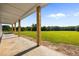 Spacious back porch with stunning views of the surrounding lush green field and tree line at 8365 Aaron Creek Church Rd, Oxford, NC 27565